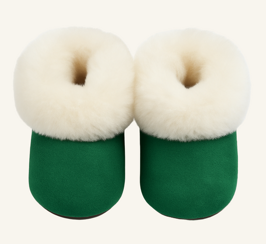 Green slippers with cream fur on a white background