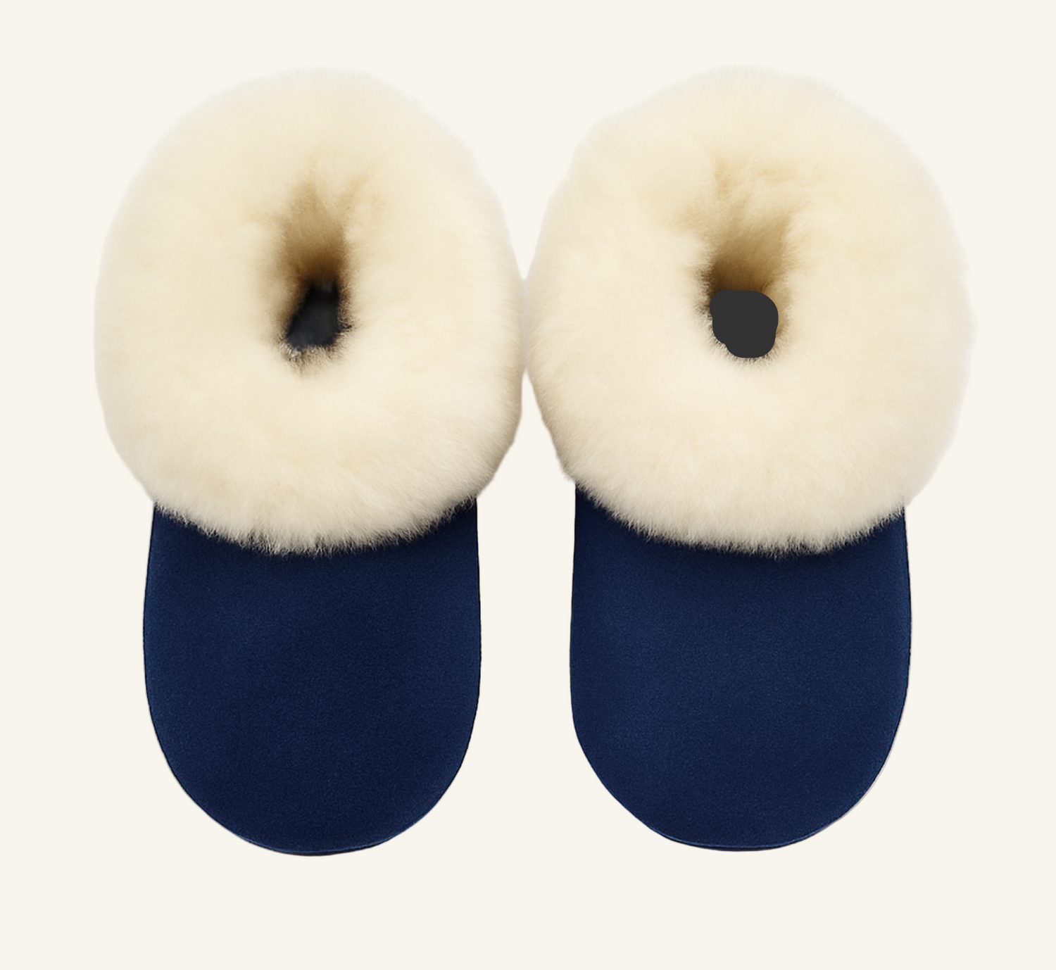 Pair of navy blue slippers with cream fur on a white background